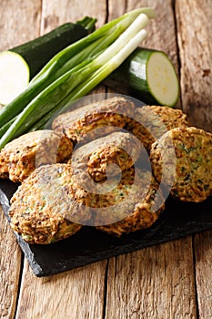 TraditionalÃÂ GreekÃÂ kolokithokeftedes zucchini and feta balls close-up on a slate board. Vertical